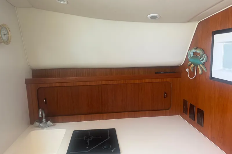 Slide: The Image of 2001 Tiara Yachts 2900 Open interior with wooden cabinetry and compact kitchen area. - 41