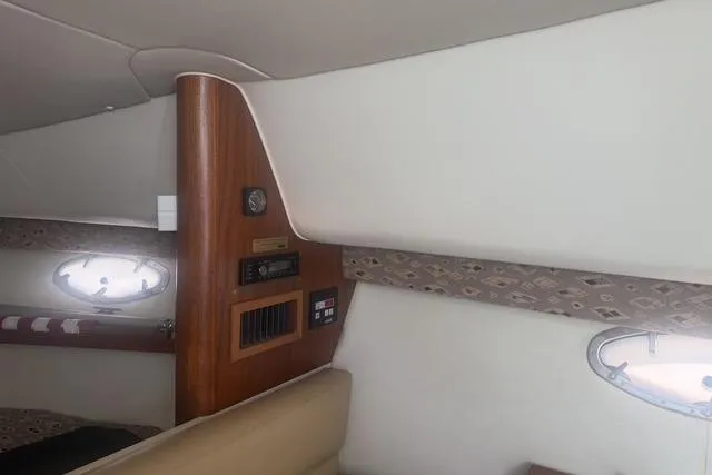 Slide: The Image of Interior cabin of 2001 Tiara Yachts 2900 Open with wood paneling and porthole. - 44