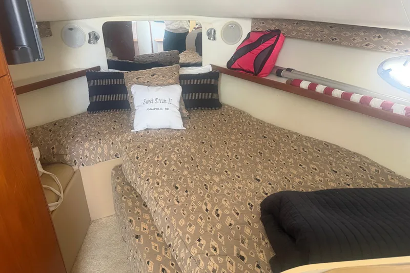 Slide: The Image of Cozy cabin interior of 2001 Tiara Yachts 2900 Open with patterned bedding and pillows. - 46