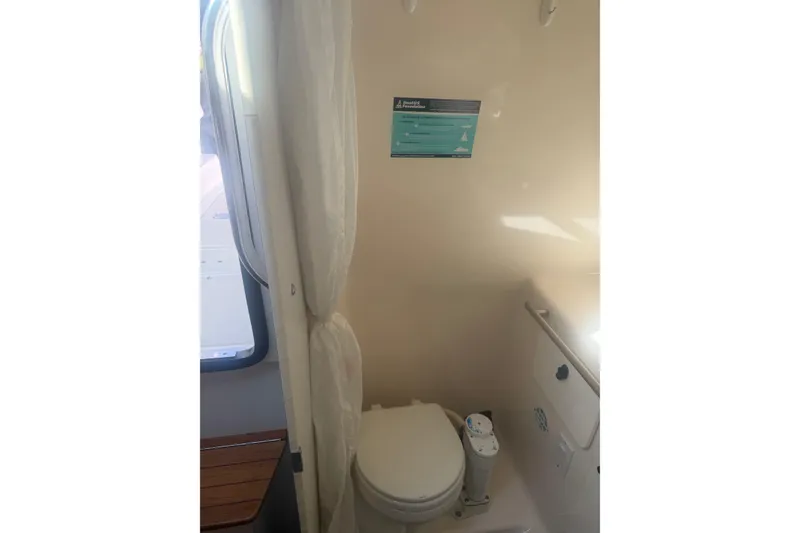 Slide: The Image of 2001 Tiara Yachts 2900 Open bathroom interior with toilet and window view. - 48