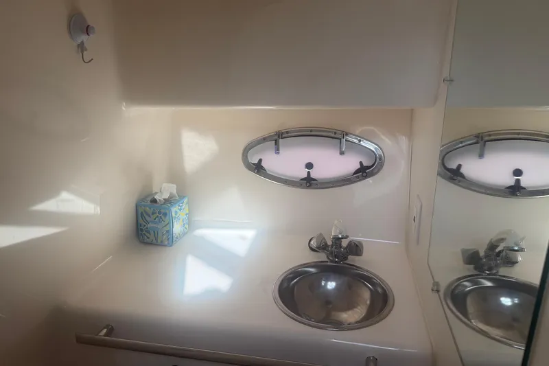 Slide: The Image of 2001 Tiara Yachts 2900 Open bathroom with sink, mirror, and tissue box. - 51