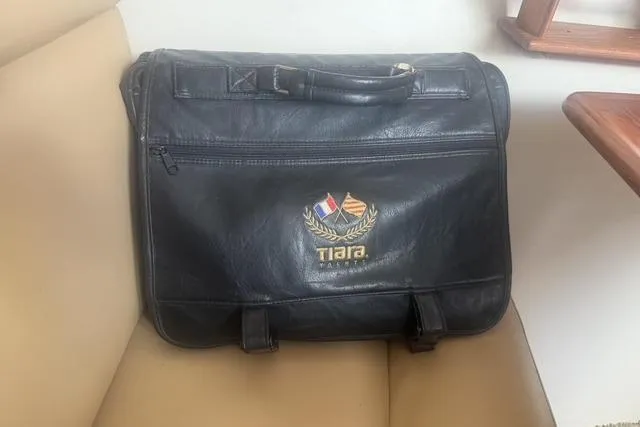 Slide: The Image of Black Tiara Yachts branded bag on beige seat, showcasing luxury boating accessory. - 53