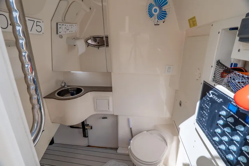 Slide: The Image of 2019 Scout 320 LXF boat interior with sink, toilet, and control panel. - 33