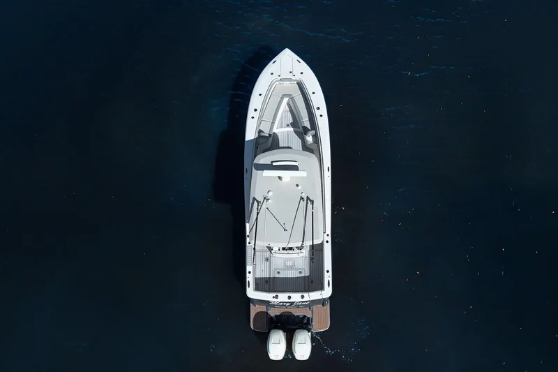 Slide: The Image of Aerial view of 2019 Scout 320 LXF boat on dark water. - 9