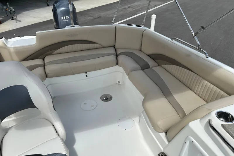 Slide: The Image of 2014 NauticStar 203SC Sport Deck boat interior with beige seating and Yamaha 115 engine. - 10