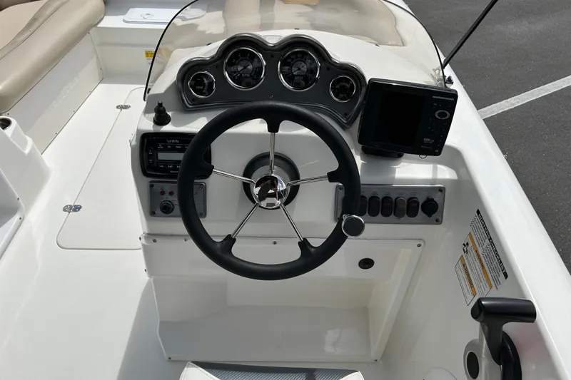 Slide: The Image of 2014 NauticStar 203SC Sport Deck boat dashboard with steering wheel and gauges. - 11