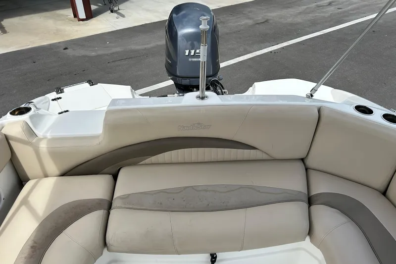 Slide: The Image of 2014 NauticStar 203SC Sport Deck boat interior with Yamaha 115 engine. - 12