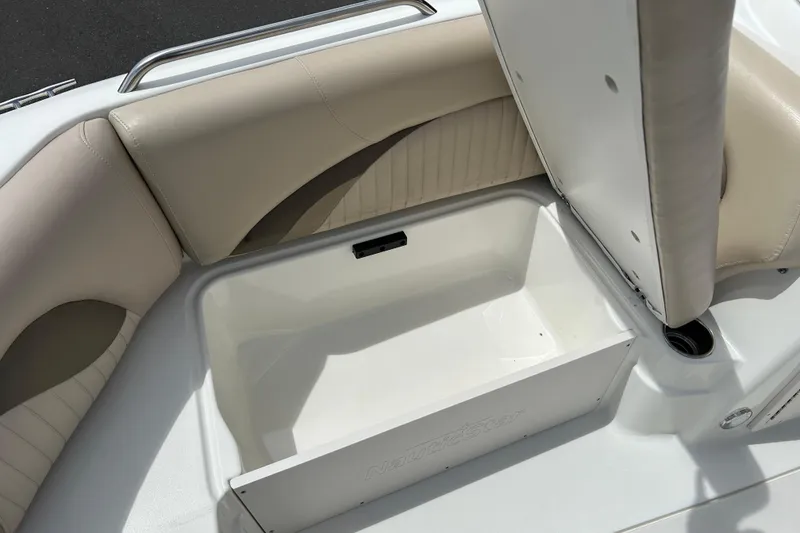 Slide: The Image of 2014 NauticStar 203SC Sport Deck boat seat storage compartment open. - 15