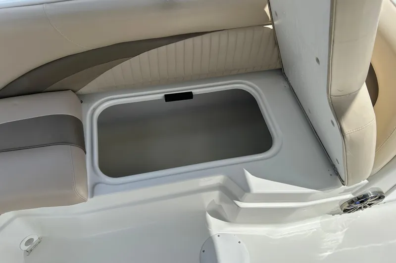 Slide: The Image of 2014 NauticStar 203SC Sport Deck boat seat storage compartment. - 17