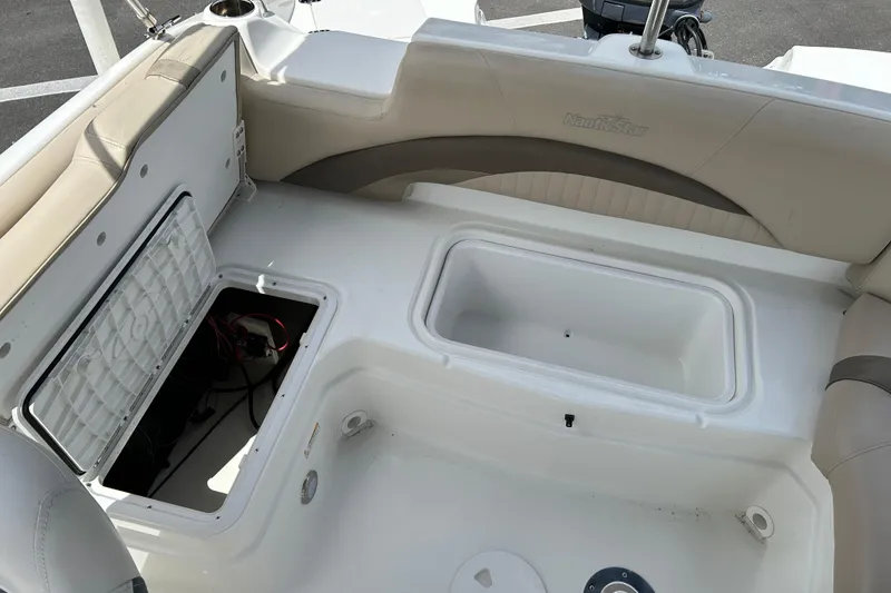 Slide: The Image of 2014 NauticStar 203SC Sport Deck boat interior with storage compartments open. - 18