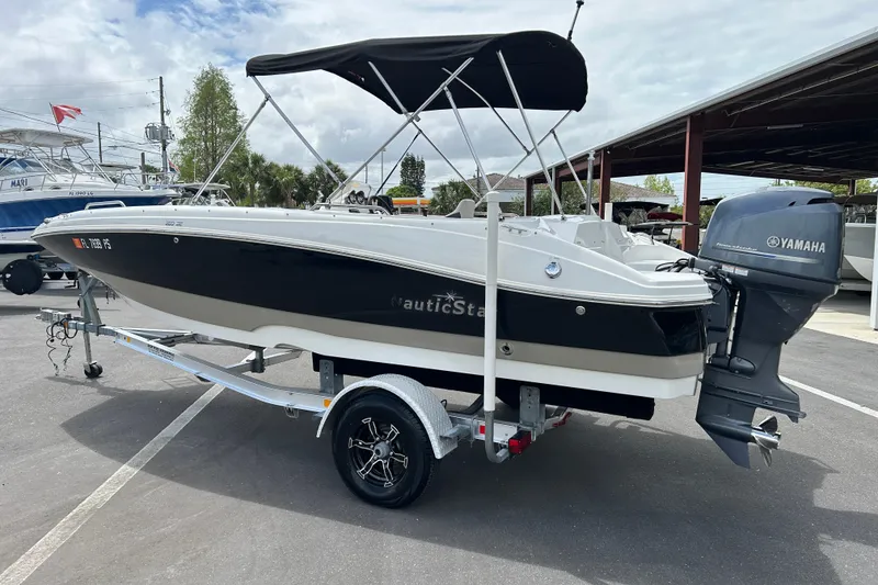 Slide: The Image of 2014 NauticStar 203SC Sport Deck boat with Yamaha outboard motor on trailer. - 4