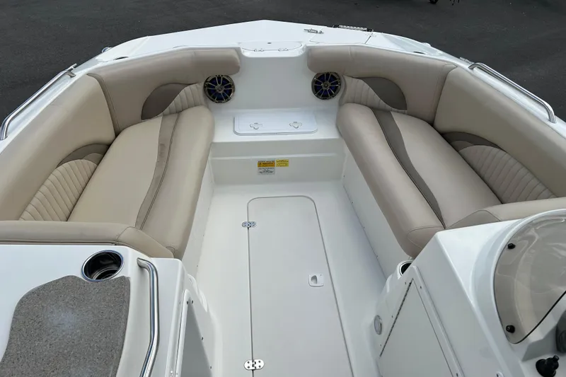 Slide: The Image of 2014 NauticStar 203SC Sport Deck interior with beige seating and cup holders. - 8