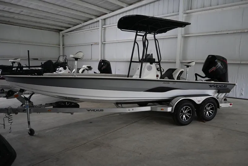 The Image of 2023 Vexus AVX2180CC boat on trailer in indoor storage facility. - 0