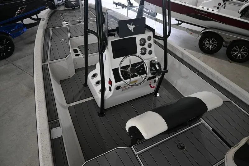 Slide: The Image of 2023 Vexus AVX2180CC boat interior with steering console and seating, showcasing modern design. - 6