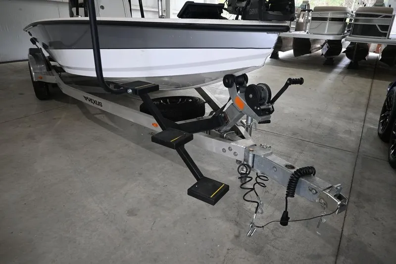 Slide: The Image of 2023 Vexus AVX2180CC boat on trailer in a garage setting. - 9