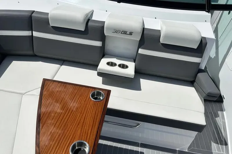 Slide: The Image of 2023 Cruisers Yachts 38 GLS OB interior with gray seating and wooden table. - 11