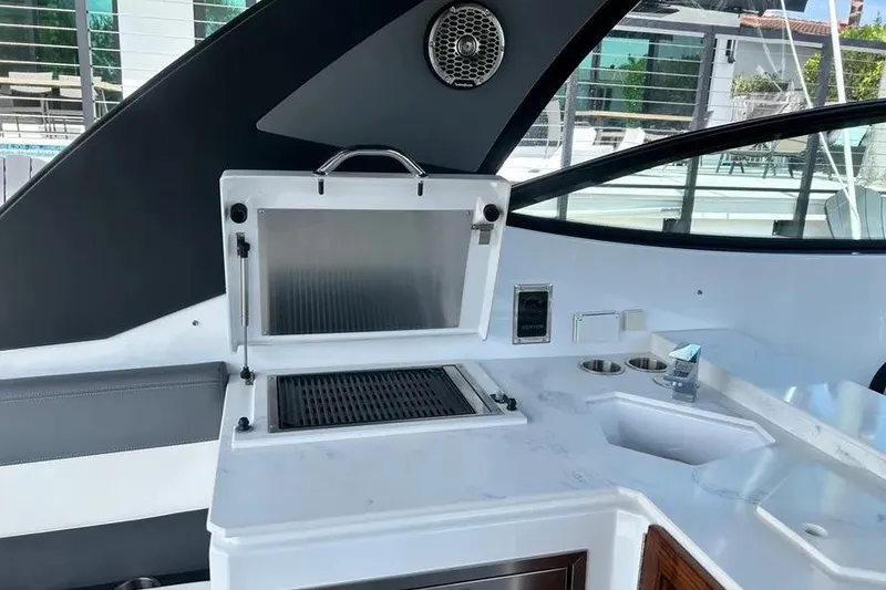 Slide: The Image of 2023 Cruisers Yachts 38 GLS OB boat interior with grill and sink area. - 15