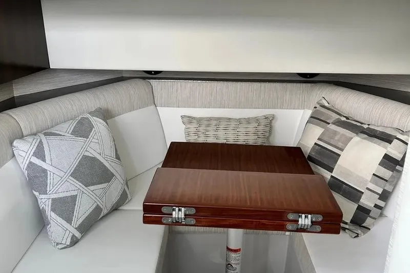 Slide: The Image of Interior of 2023 Cruisers Yachts 38 GLS OB with cozy seating and wooden table. - 17