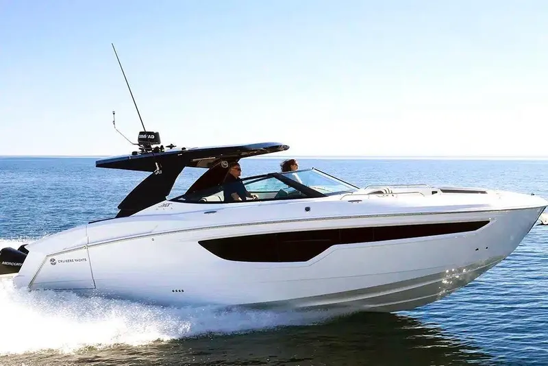 Slide: The Image of 2023 Cruisers Yachts 38 GLS OB cruising on open water under clear skies. - 2