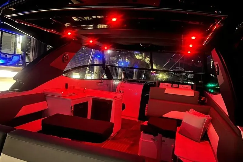 Slide: The Image of Interior of 2023 Cruisers Yachts 38 GLS OB with red ambient lighting. - 23