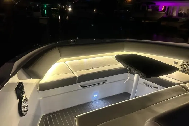 Slide: The Image of Luxurious seating area on 2023 Cruisers Yachts 38 GLS OB, illuminated at night. - 24