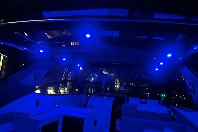 Slide: The Image of 2023 Cruisers Yachts 38 GLS OB interior with blue LED lighting at night. - 25