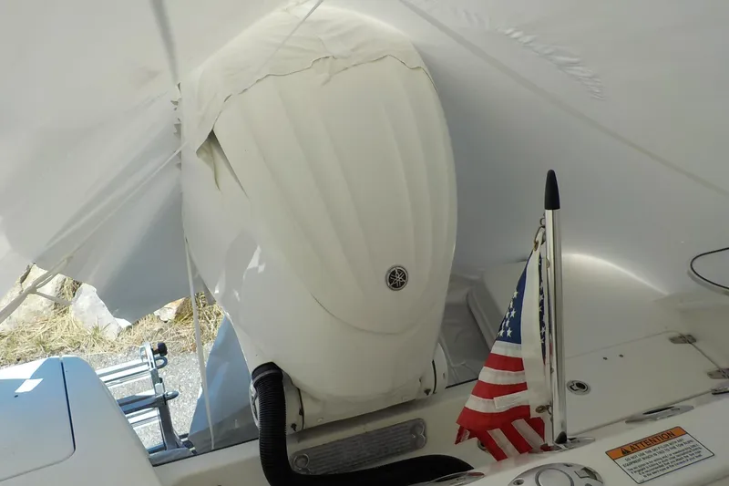 Slide: The Image of 2022 Edgewater 230CC boat with Yamaha outboard motor and American flag. - 12
