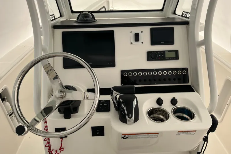 Slide: The Image of Edgewater 230CC 2022 boat console with steering wheel, controls, and electronic displays. - 2