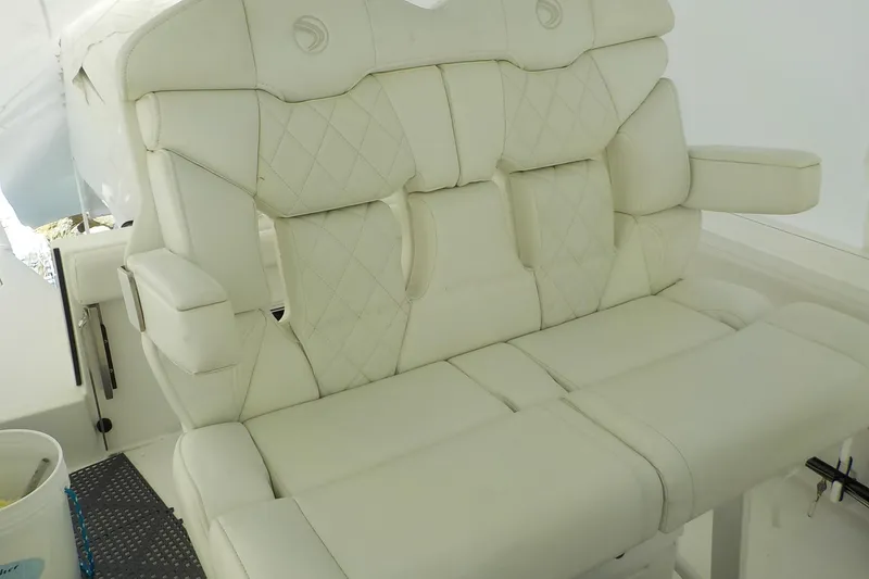 Slide: The Image of Luxurious white seating on 2022 Edgewater 230CC boat, featuring diamond-pattern upholstery. - 5