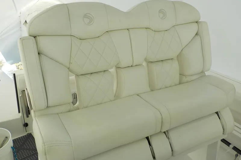 Slide: The Image of Luxurious white seating on 2022 Edgewater 230CC boat, featuring diamond-patterned upholstery. - 6