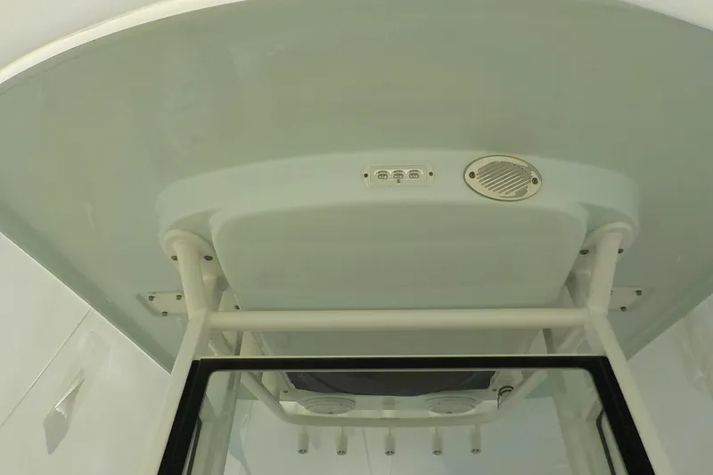 Slide: The Image of 2022 Edgewater 230CC boat T-top with integrated speaker and light fixtures. - 7