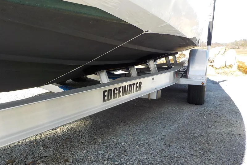 Slide: The Image of Edgewater 230CC 2022 boat on trailer, showcasing hull and trailer branding. - 9