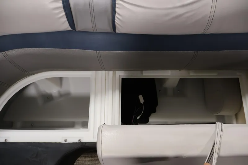 Slide: The Image of Sweetwater 2186 boat storage compartments, 2018 model, with cushioned seating and open hatches. - 16