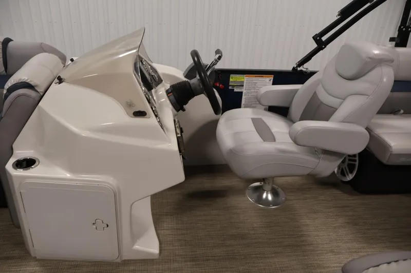 Slide: The Image of 2018 Sweetwater 2186 boat interior with steering console and cushioned captain's chair. - 17