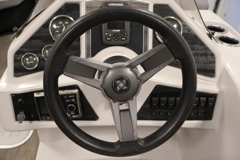 Slide: The Image of Steering wheel and dashboard of a 2018 Sweetwater 2186 boat with gauges and controls. - 20