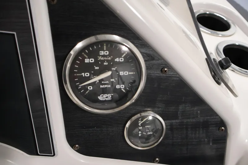 Slide: The Image of Dashboard of a 2018 Sweetwater 2186 boat with speedometer and fuel gauge. - 23