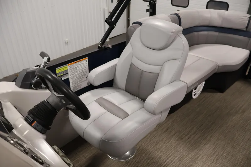 Slide: The Image of Luxurious Sweetwater 2186 boat interior with plush seating and steering wheel, 2018 model. - 27