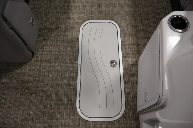 Slide: The Image of Floor hatch on 2018 Sweetwater 2186 boat with textured carpet and sleek design. - 28