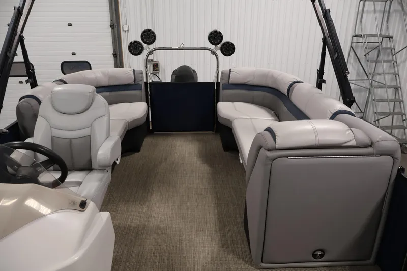 Slide: The Image of Interior of a 2018 Sweetwater 2186 pontoon boat with plush seating and steering console. - 30