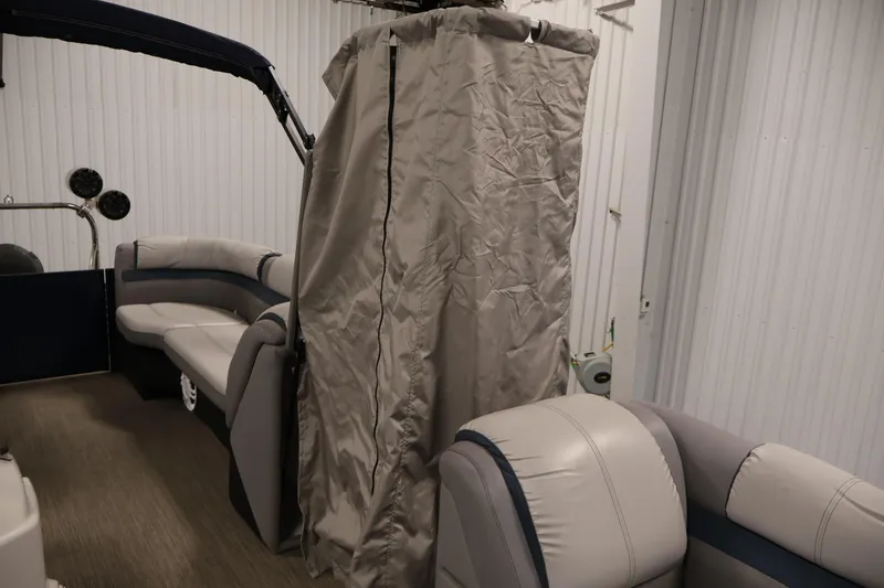 Slide: The Image of Interior of a 2018 Sweetwater 2186 boat with seating and privacy curtain. - 31
