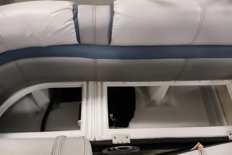 Slide: The Image of Interior seating storage of 2018 Sweetwater 2186 boat, featuring cushioned seats and open compartments. - 33