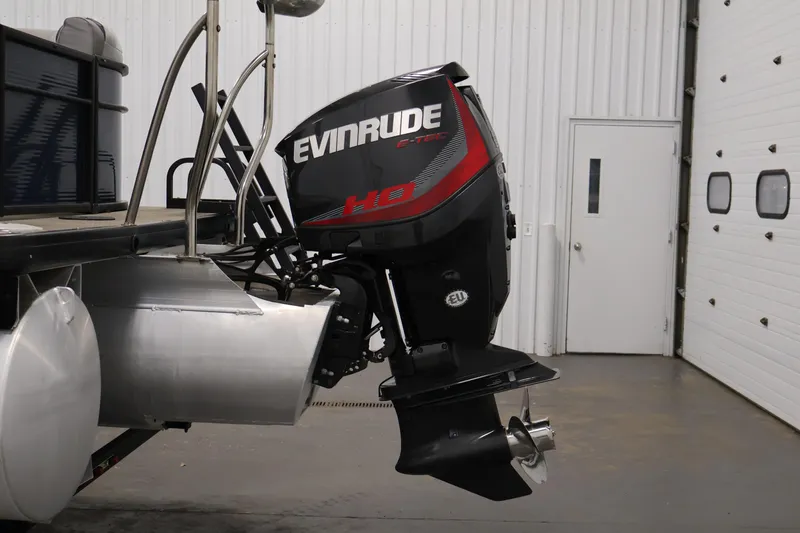Slide: The Image of Sweetwater 2186 boat with Evinrude outboard motor in a garage, 2018 model. - 38