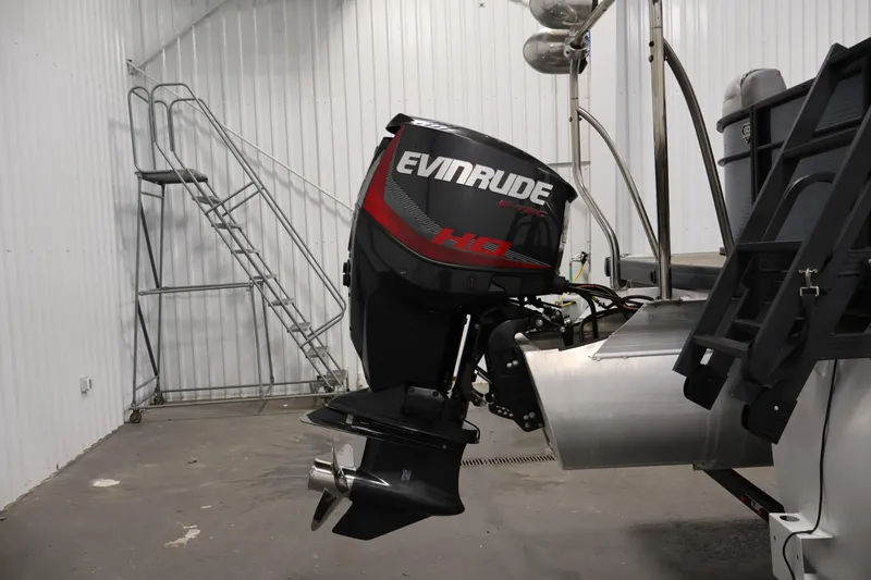 Slide: The Image of 2018 Sweetwater 2186 boat with Evinrude outboard motor in a storage facility. - 39