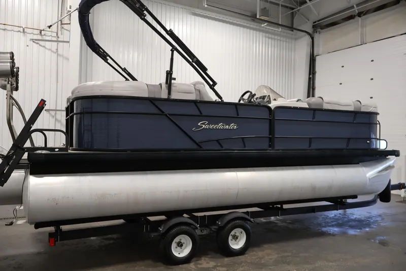 Slide: The Image of 2018 Sweetwater 2186 pontoon boat on trailer in indoor storage facility. - 4
