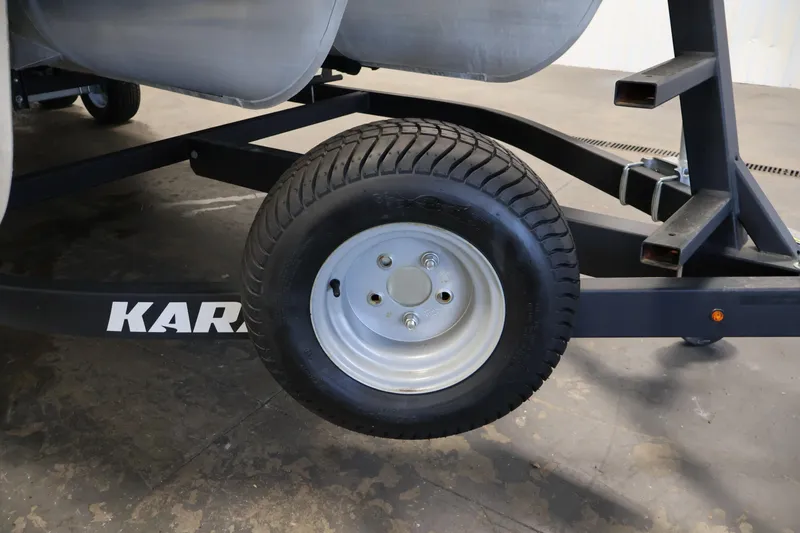 Slide: The Image of Trailer wheel of a 2018 Sweetwater 2186 pontoon boat on a Karavan trailer. - 45