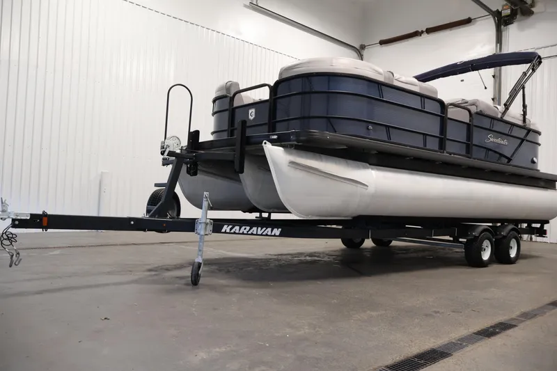 Slide: The Image of 2018 Sweetwater 2186 pontoon boat on Karavan trailer in indoor storage. - 46