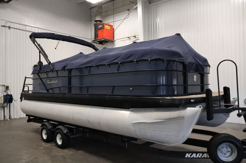 Slide: The Image of Pontoon boat Sweetwater 2186, 2018 model, covered and on trailer in indoor storage. - 48