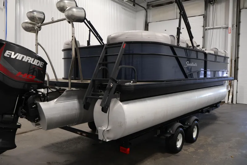 Slide: The Image of 2018 Sweetwater 2186 pontoon boat with Evinrude motor in indoor storage. - 5