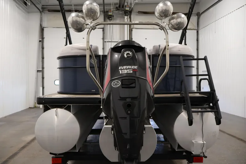 Slide: The Image of 2018 Sweetwater 2186 pontoon boat with Evinrude 135 engine in a garage setting. - 6