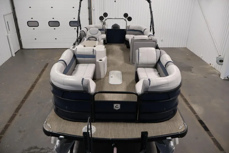 Slide: The Image of 2018 Sweetwater 2186 pontoon boat with spacious seating in a garage setting. - 9